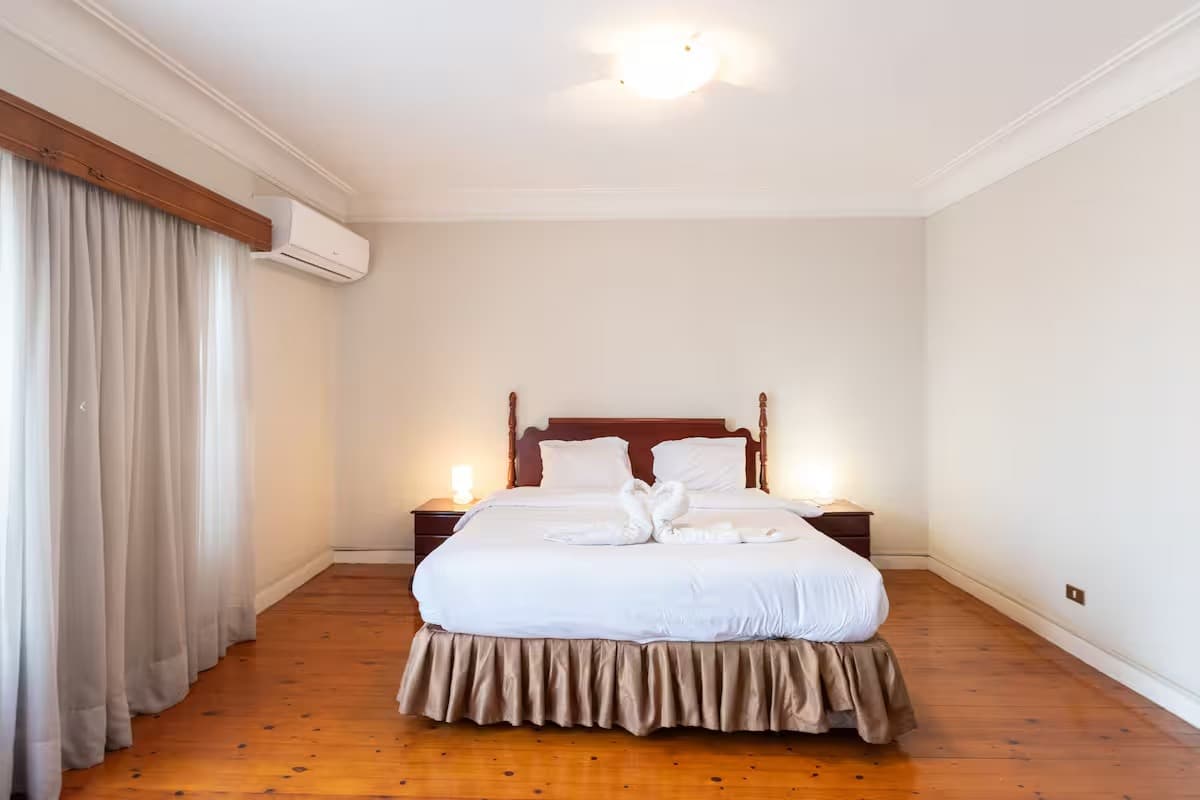 Elegant bedroom with wooden floors and comfortable furnishing