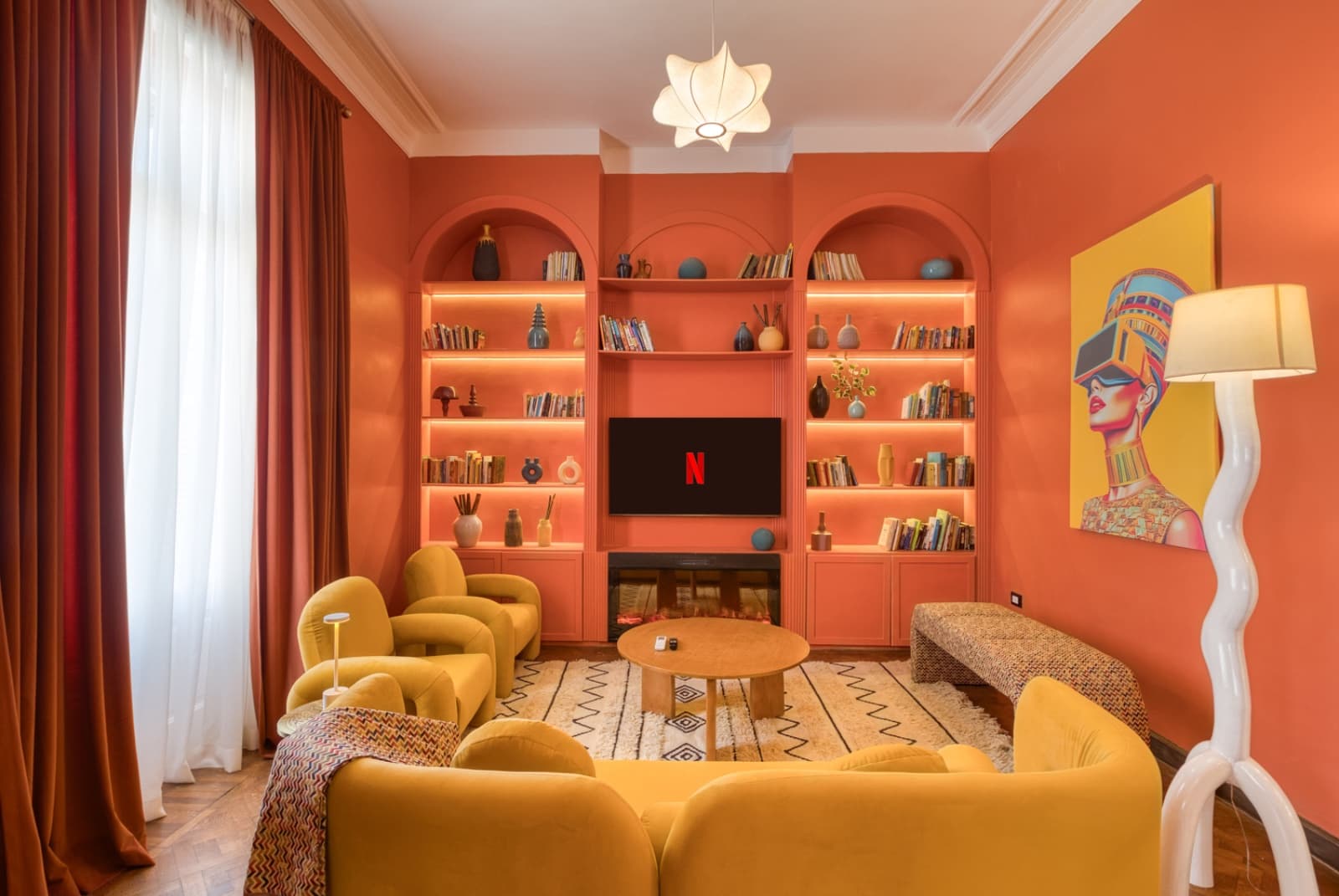 Dramatic living room with built-in shelving and Egyptian-inspired artwork