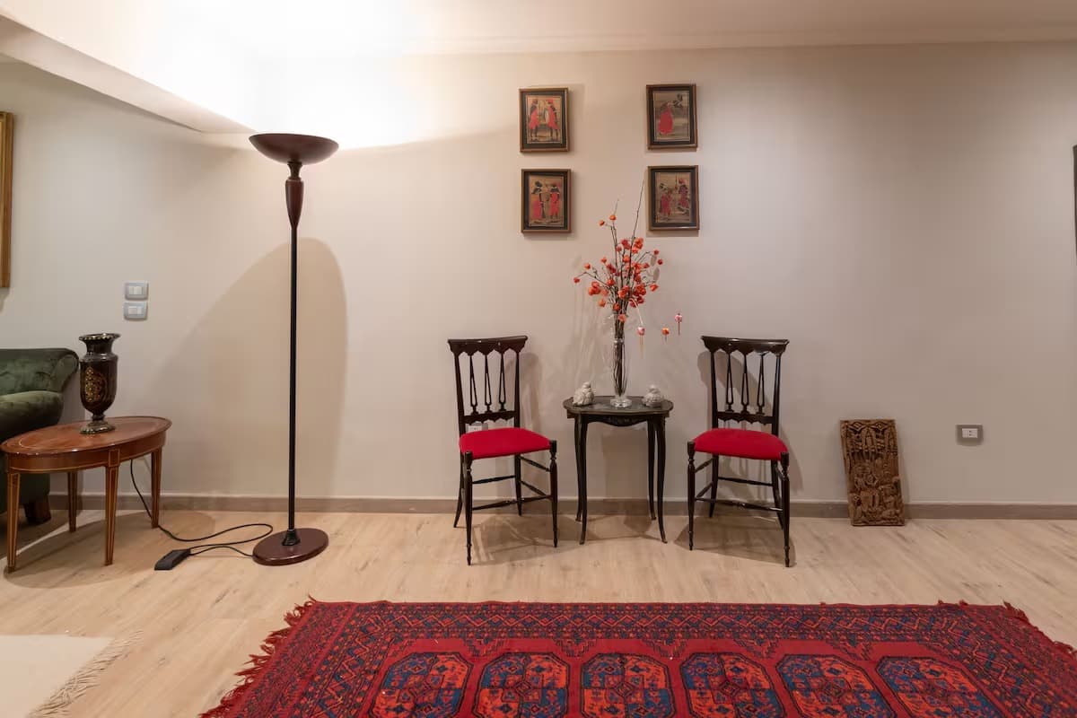 Charming seating area with traditional chairs and Persian rug