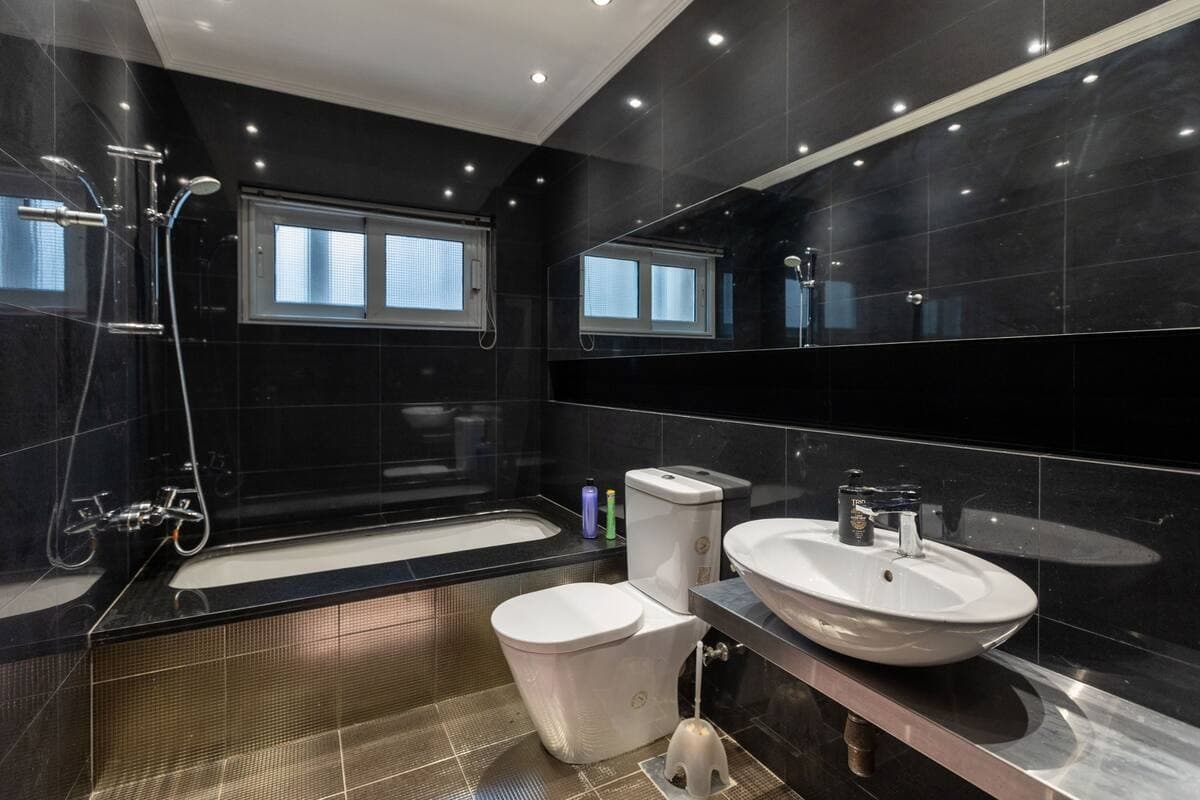 Luxurious modern bathroom with black marble walls